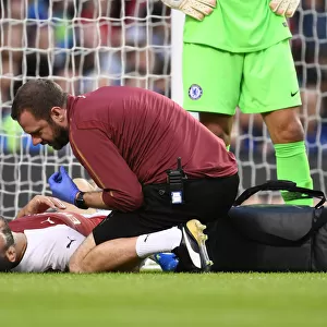 Arsenal's Chris Morgan Tends to Injured Sead Kolasinac during Arsenal v Chelsea Pre-Season Friendly (2018-19)