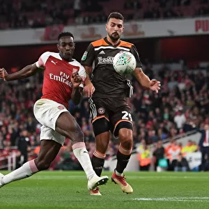 Arsenal's Danny Welbeck Faces Off Against Brentford's Ezri Konsa in Carabao Cup Clash