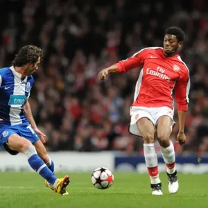 Arsenal's Dominance: Abou Diaby Celebrates Against Nuno Coelho and FC Porto in the 2010 UEFA Champions League Arsenal's Dominance: Abou Diaby Celebrates Against Nuno Coelho and FC Porto in the 2010 UEFA Champions League