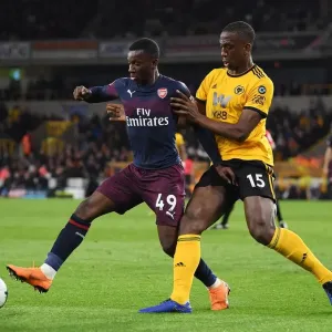 Arsenal's Eddie Nketiah Battles Willy Boly in Intense Wolverhampton Wanderers Clash Arsenal's Eddie Nketiah Battles Willy Boly in Intense Wolverhampton Wanderers Clash