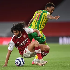 Arsenal's Elneny Fights for Possession Amid Empty Emirates: Arsenal vs. West Bromwich Albion (2020-21)