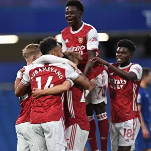 Arsenal's Emile Smith Rowe, Aubameyang, Saka, and Partey Celebrate Goal Against Chelsea in Empty Stamford Bridge (2020-21 Premier League)