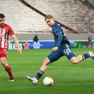 Arsenal's Emile Smith Rowe Clashes with Olympiacos Sokratis in Empty Europa League Arena