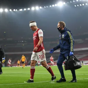 Arsenal's Empty Emirates: David Luiz Receives Treatment Alone Amidst Quiet Stadium Crowds (2020-21 Premier League: Arsenal vs. Wolverhampton Wanderers) Arsenal's Empty Emirates: David Luiz Receives Treatment Alone Amidst Quiet Stadium Crowds (2020-21 Premier League: Arsenal vs. Wolverhampton Wanderers)