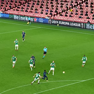 Arsenal's Emirates Stadium: A Ghostly Arena in Europa League Match against Rapid Wien (December 2020)