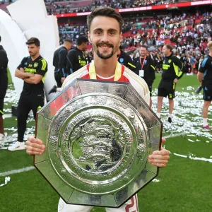 Arsenal's Fabio Vieira Celebrates FA Community Shield Victory over Manchester City (2023-24) Arsenal's Fabio Vieira Celebrates FA Community Shield Victory over Manchester City (2023-24)