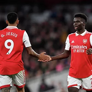 Arsenal's Gabriel Jesus and Bukayo Saka Share a Moment Amidst the Intensity of the Arsenal v Chelsea Rivalry (2022-23)