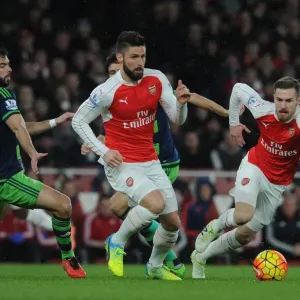 Arsenal's Giroud and Ramsey Outmaneuver Swansea's Amat during Intense Premier League Showdown