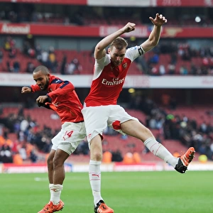 Arsenal's Glory: Theo Walcott and Per Mertesacker Celebrate Hard-Fought Victory Over Manchester United (2015/16 Premier League)