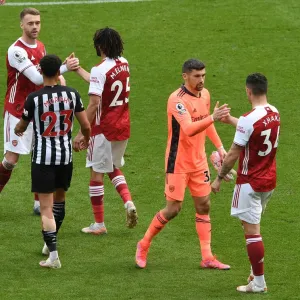 Arsenal's Granit Xhaka Celebrates with Mat Ryan after Newcastle United Win: 2020-21 Premier League Clash Amidst Empty St. James Park
