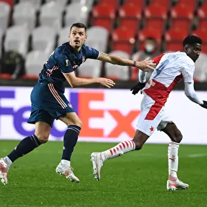 Arsenal's Granit Xhaka Clashes with Slavia Praha's Peter Olayinka in UEFA Europa League Quarterfinal: Prague Showdown