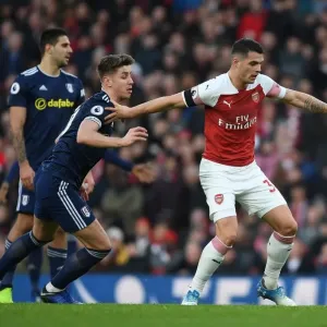 Arsenal's Granit Xhaka Fends Off Fulham's Tom Cairney in Premier League Clash