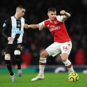 Arsenal's Granit Xhaka Holds Off Newcastle's Miguel Almiron During Premier League Clash Arsenal's Granit Xhaka Holds Off Newcastle's Miguel Almiron During Premier League Clash