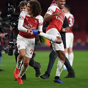 Arsenal's Guendouzi and Aubameyang: Celebrating a Hard-Fought Victory Over Tottenham