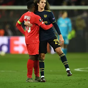 Arsenal's Guendouzi Embraces Mpoku After Standard Liege Clash in Europa League