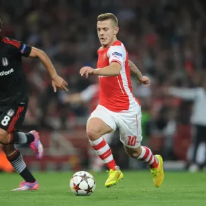 Arsenal's Jack Wilshere Clashes with Besiktas Veli Kavlak in UEFA Champions League Qualifier