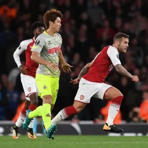 Arsenal's Jack Wilshere Clashes with FC Köln's Yuya Osako in Europa League Showdown