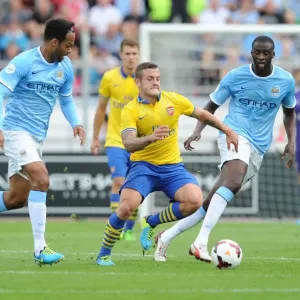 Arsenal's Jack Wilshere Clashes with Manchester City's Yaya Toure and Joleon Lescott during Pre-Season Friendly Arsenal's Jack Wilshere Clashes with Manchester City's Yaya Toure and Joleon Lescott during Pre-Season Friendly