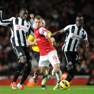 Arsenal's Jack Wilshere Clashes with Newcastle's Ba and Tiote in Premier League Showdown