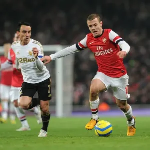 Arsenal's Jack Wilshere Clashes with Swansea's Leon Britton in FA Cup Third Round Replay Arsenal's Jack Wilshere Clashes with Swansea's Leon Britton in FA Cup Third Round Replay