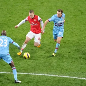 Arsenal's Jack Wilshere Faces Off Against Mark Noble and Alou Diarra of West Ham United