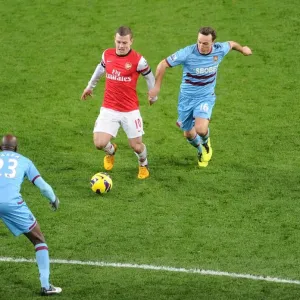 Arsenal's Jack Wilshere Faces Off Against West Ham's Mark Noble and Alou Diarra