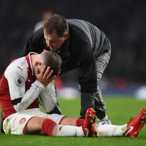 Arsenal's Jack Wilshere Receives Medical Attention from Physio Colin Lewin during Premier League Match Arsenal's Jack Wilshere Receives Medical Attention from Physio Colin Lewin during Premier League Match