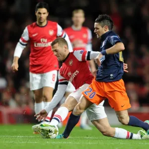 Arsenal's Jack Wilshere Tackles Montpellier's Remy Cabella in Champions League Clash