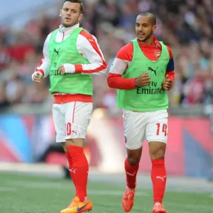 Arsenal's Jack Wilshere and Theo Walcott Warm Up for FA Cup Semi-Final Against Reading