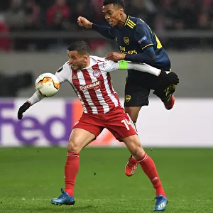 Arsenal's Joe Willock Faces Off Against Olympiacos Omar Elabdellaoui in Europa League Clash