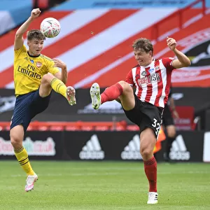 Arsenal's Kieran Tierney Clashes with Sheffield United's Sander Berge in FA Cup Quarterfinal