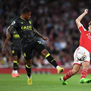 Arsenal's Kieran Tierney Fends Off Aston Villa's Leon Bailey During Premier League Clash at Emirates Stadium