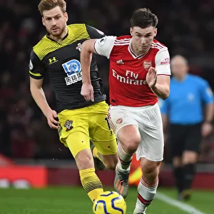 Arsenal's Kieran Tierney Outmaneuvers Southampton's Stuart Armstrong in Premier League Clash