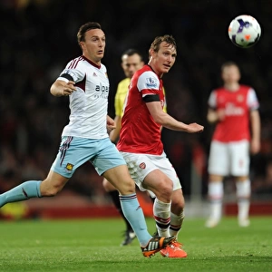 Arsenal's Kim Kallstrom Faces Mark Noble Pressure in Premier League Clash (2013/14)