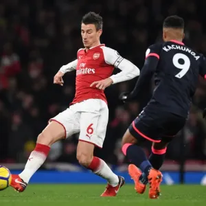 Arsenal's Koscielny Clashes with Huddersfield's Kachunga in Premier League Showdown Arsenal's Koscielny Clashes with Huddersfield's Kachunga in Premier League Showdown