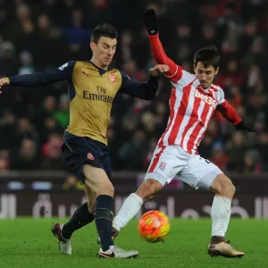 Arsenal's Koscielny Goes Head-to-Head with Stoke's Bojan in Intense Premier League Showdown