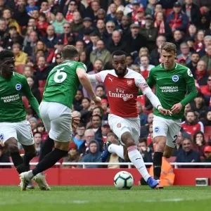 Arsenal's Lacazette Clashes with Brighton's Defenders during Premier League Showdown