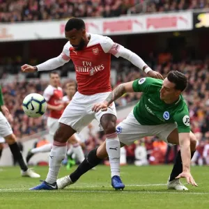 Arsenal's Lacazette Faces Off Against Brighton's Dunk in Intense Premier League Clash