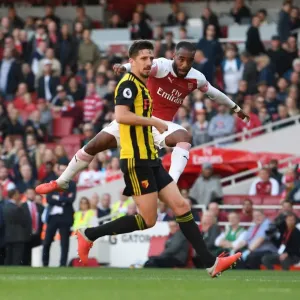 Arsenal's Lacazette Faces Off Against Cathcart in Intense Premier League Clash
