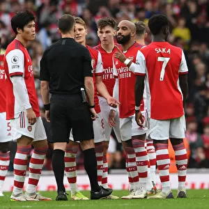 Arsenal's Lacazette and Tomiyasu Confer with Referee during Arsenal vs Manchester City (2021-22)