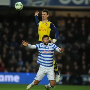 Arsenal's Laurent Koscielny Soars Above QPR's Charlie Austin in Premier League Clash