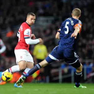 Arsenal's Lukas Podolski Clashes with Fulham's Brede Hangeland during the 2013-14 Premier League Match Arsenal's Lukas Podolski Clashes with Fulham's Brede Hangeland during the 2013-14 Premier League Match
