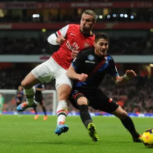 Arsenal's Lukas Podolski Faces Off Against Crystal Palace's Joel Ward in Premier League Showdown