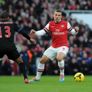 Arsenal's Lukas Podolski Tangles with Crystal Palace's Jason Puncheon in Premier League Clash