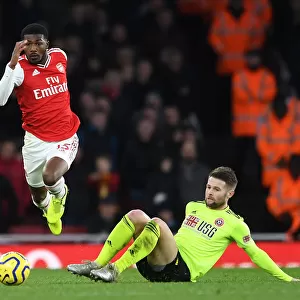 Arsenal's Maitland-Niles Outmaneuvers Sheffield United's Norwood in Premier League Clash