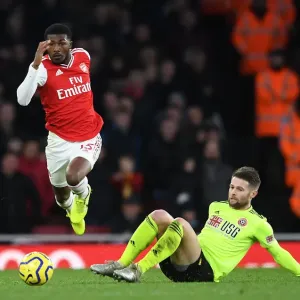 Arsenal's Maitland-Niles Outmaneuvers Sheffield United's Norwood in Premier League Clash