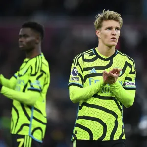 Arsenal's Martin Odegaard Celebrates with Fans after Aston Villa Victory (2023-24) Arsenal's Martin Odegaard Celebrates with Fans after Aston Villa Victory (2023-24)