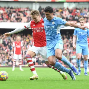 Arsenal's Martin Odegaard Clashes with Manchester City's Rodri: A Premier League Showdown at Emirates Stadium