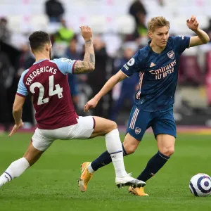 Arsenal's Martin Odegaard Outmaneuvers West Ham's Ryan Fredericks in Premier League Clash Arsenal's Martin Odegaard Outmaneuvers West Ham's Ryan Fredericks in Premier League Clash