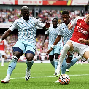 Arsenal's Martinelli Faces Off Against Aurier and Danilo of Nottingham Forest in Intense Premier League Clash (2023-24)